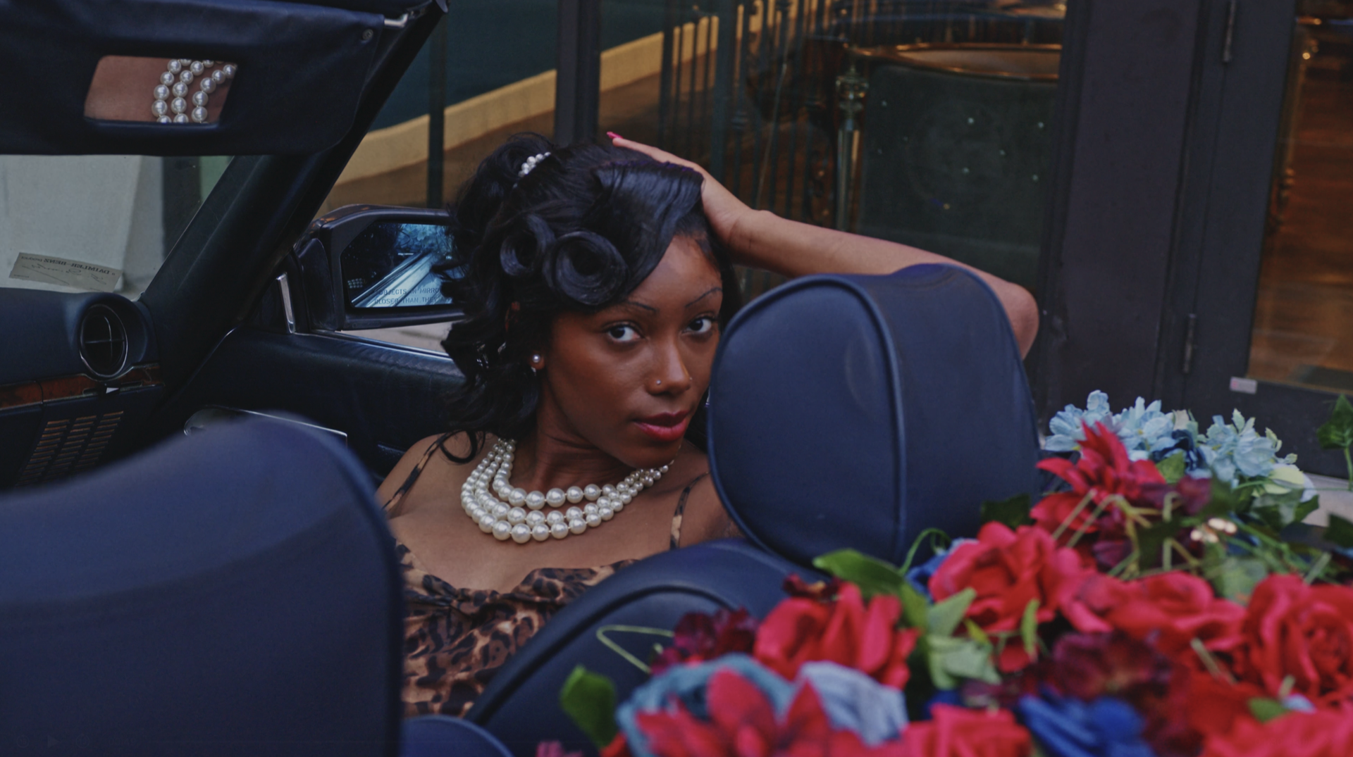 A woman seated in a convertible