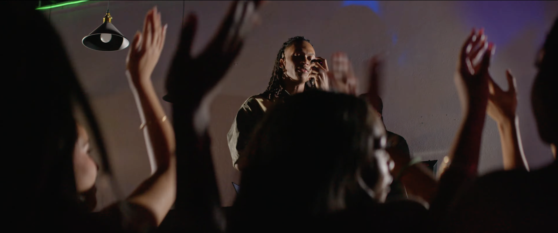 A performer singing to a crowd