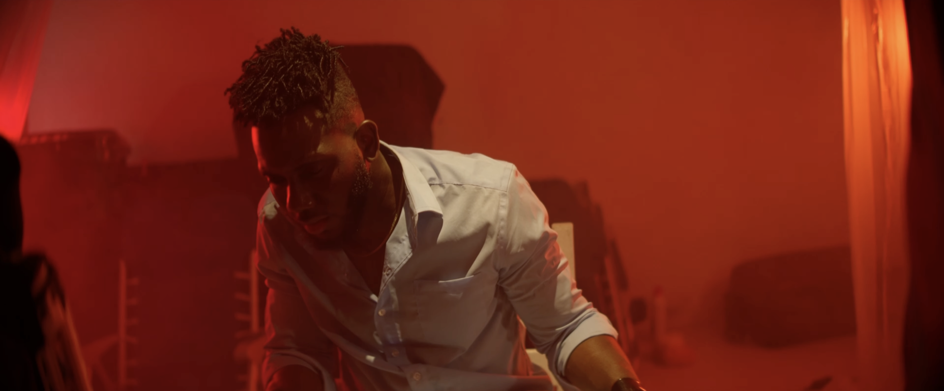 A man leaning forward in red light