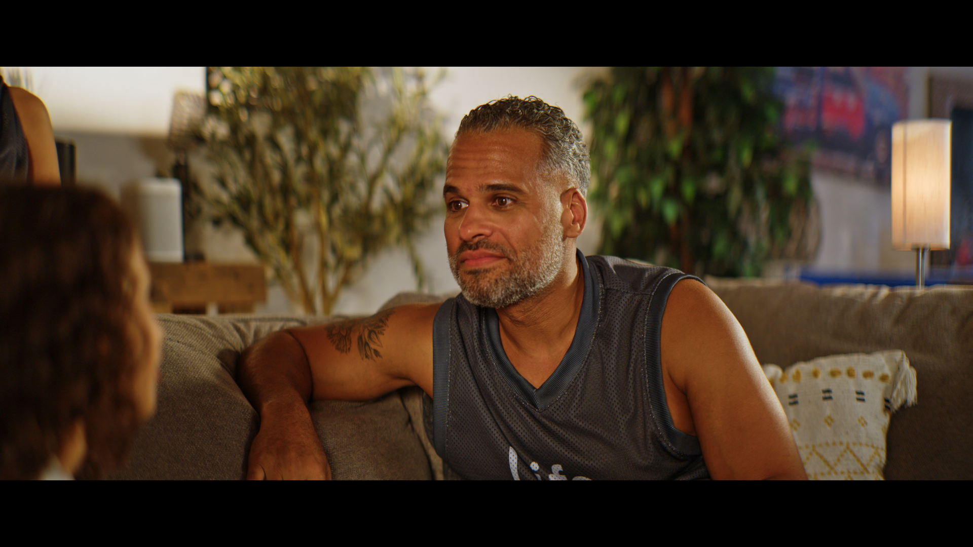 A man in a jersey on a couch