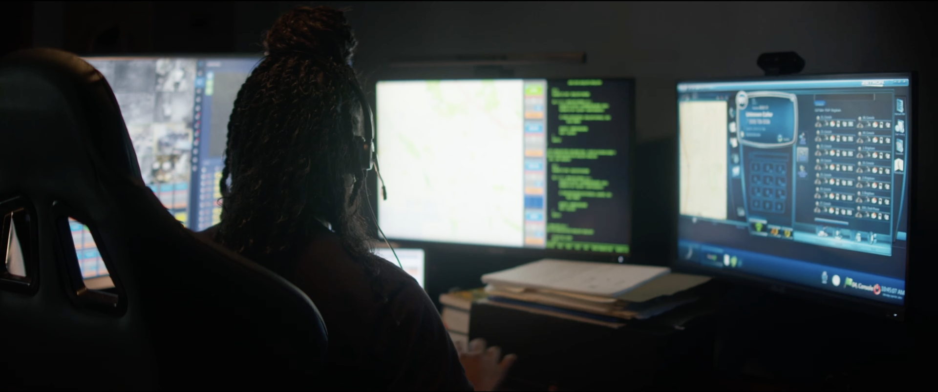 A woman at a bank of monitors