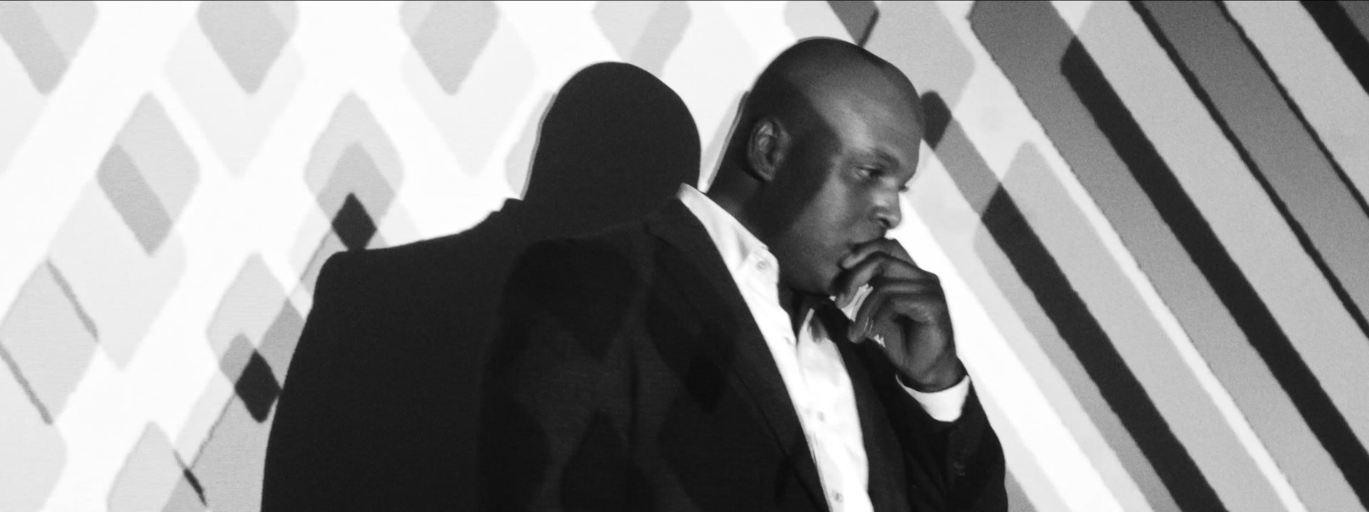 A man thinking in front of a projector