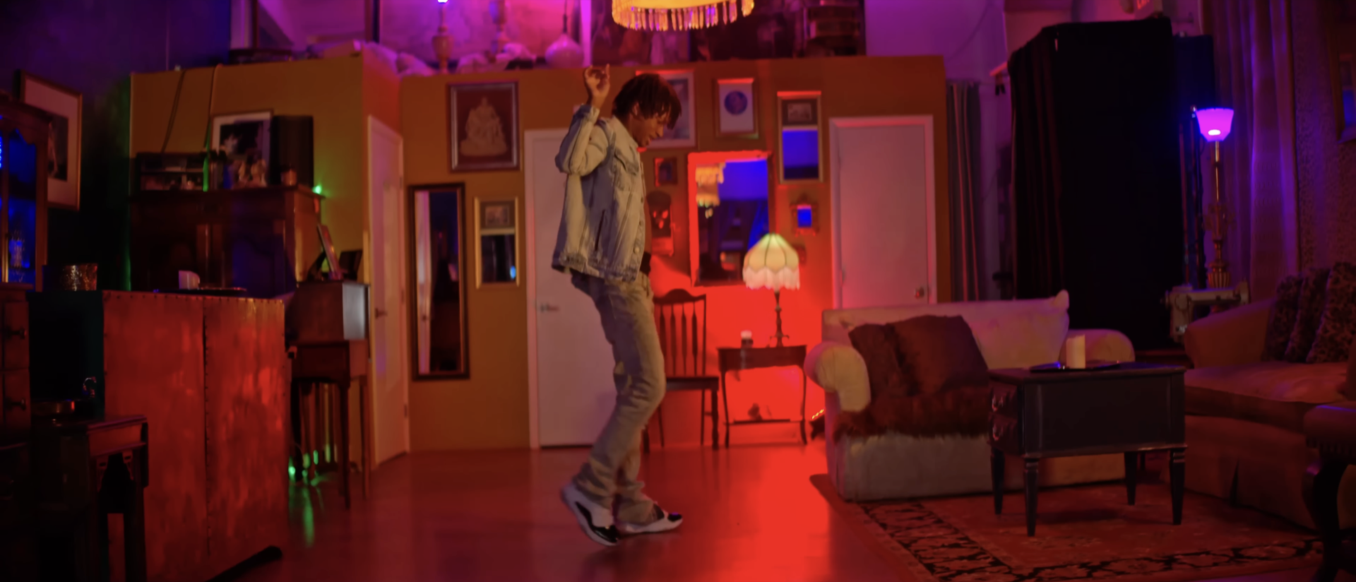 A man dancing in a red-lit room