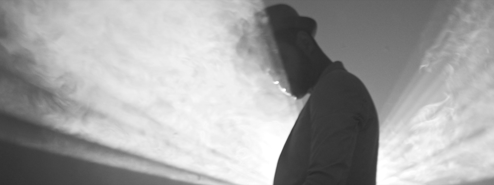 A man in profile through smoke