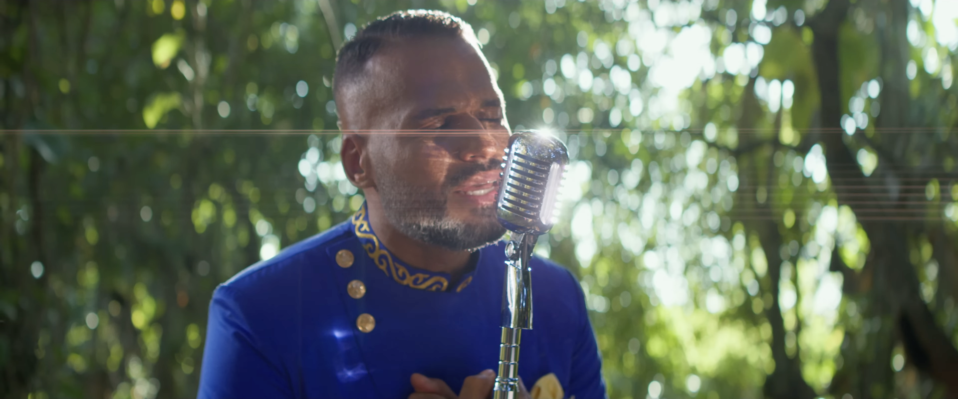 A man singing into a vintage microphone