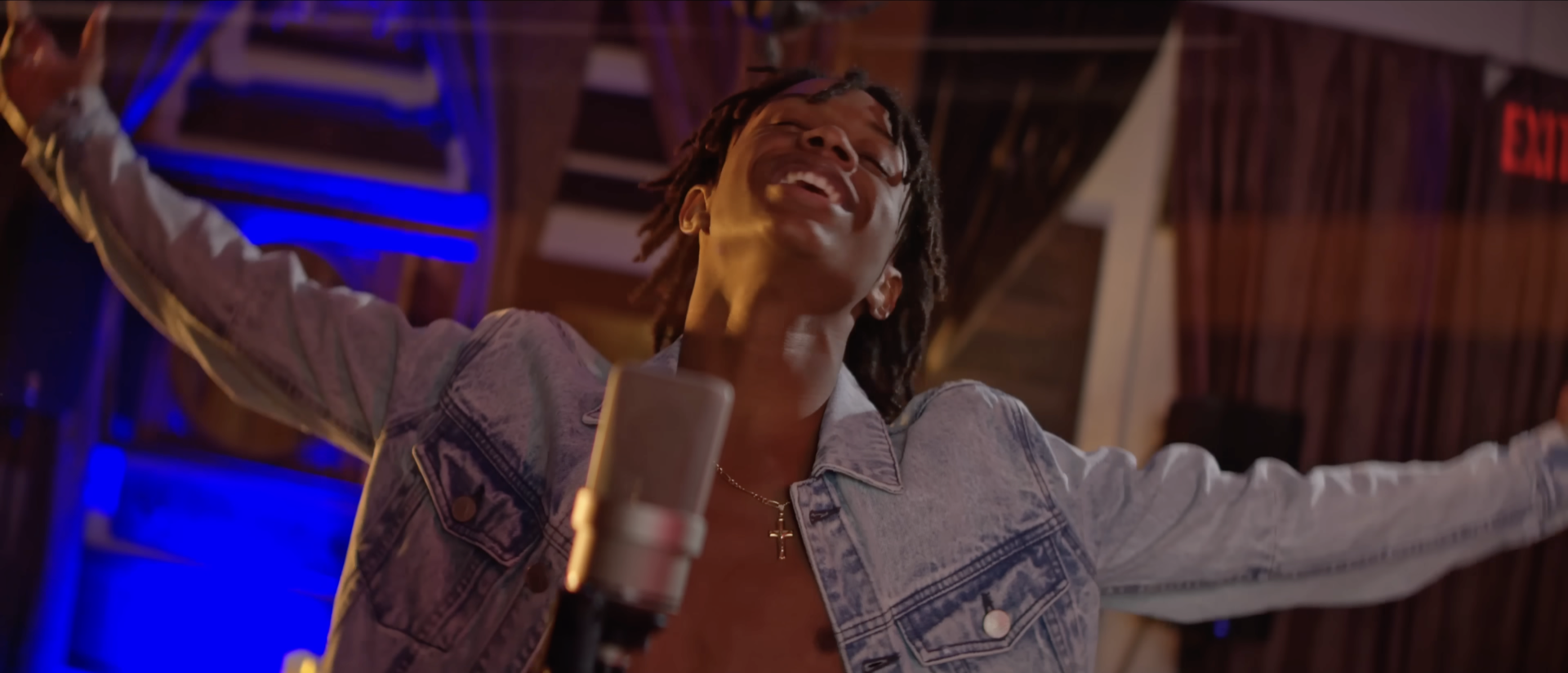 A man singing into a studio microphone
